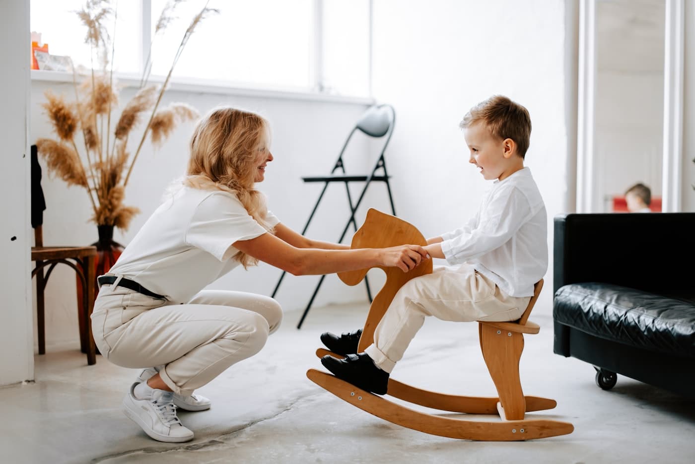 A caregiver playing with a child outdoors